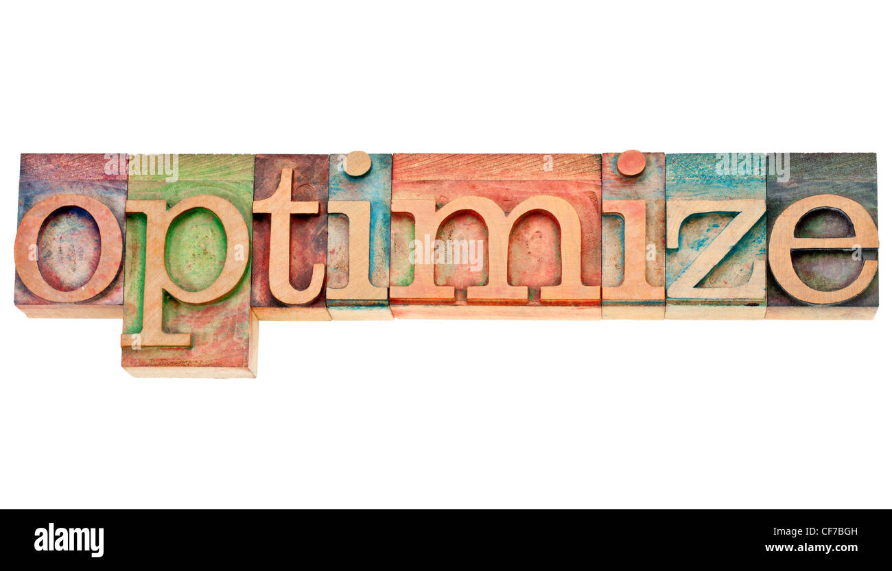 optimize - isolated word in vintage wood letterpress printing blocks stained by colorful inks Stock Photo