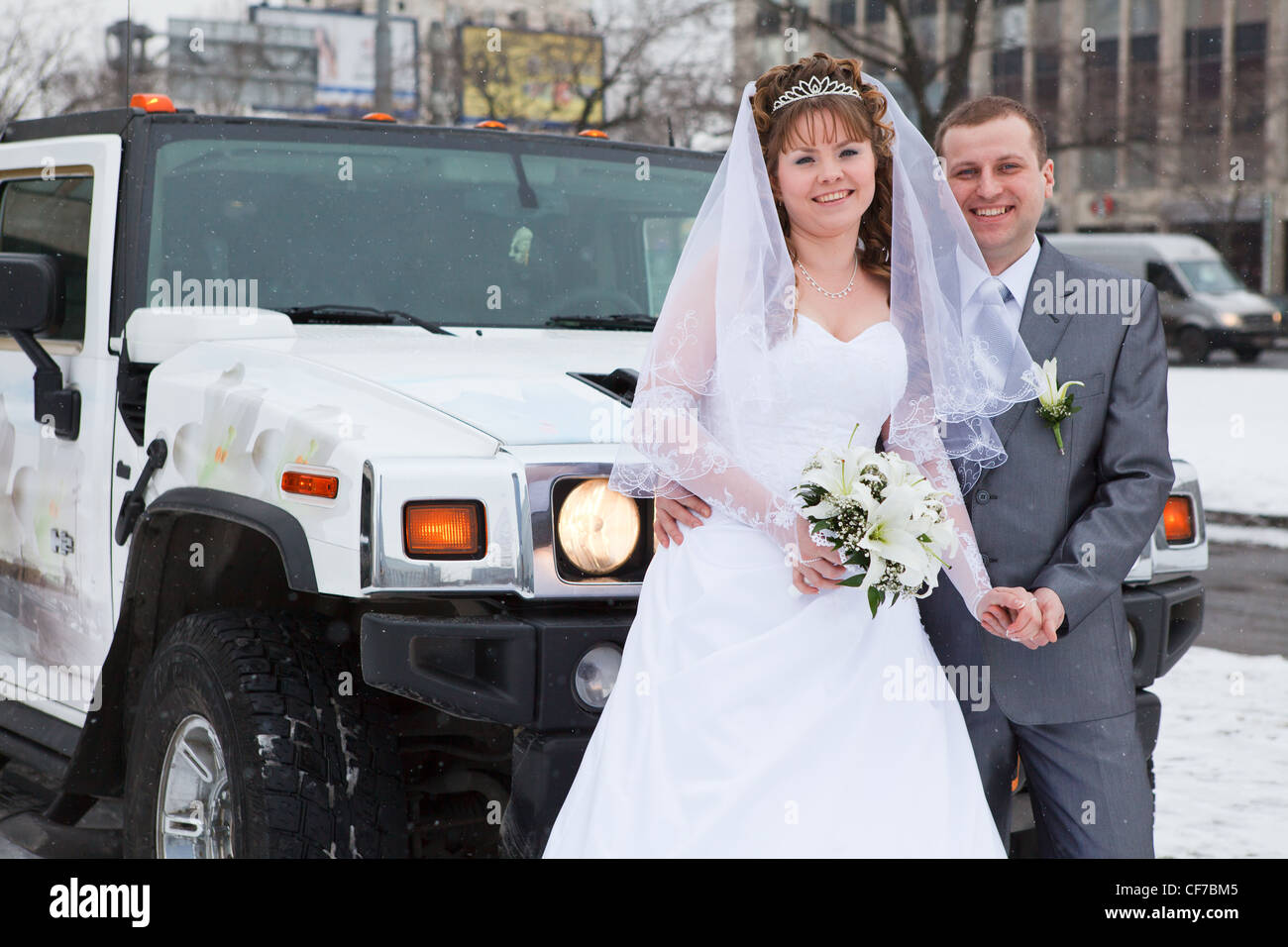 Bride and groom standing near car limousine in winter season Stock ...