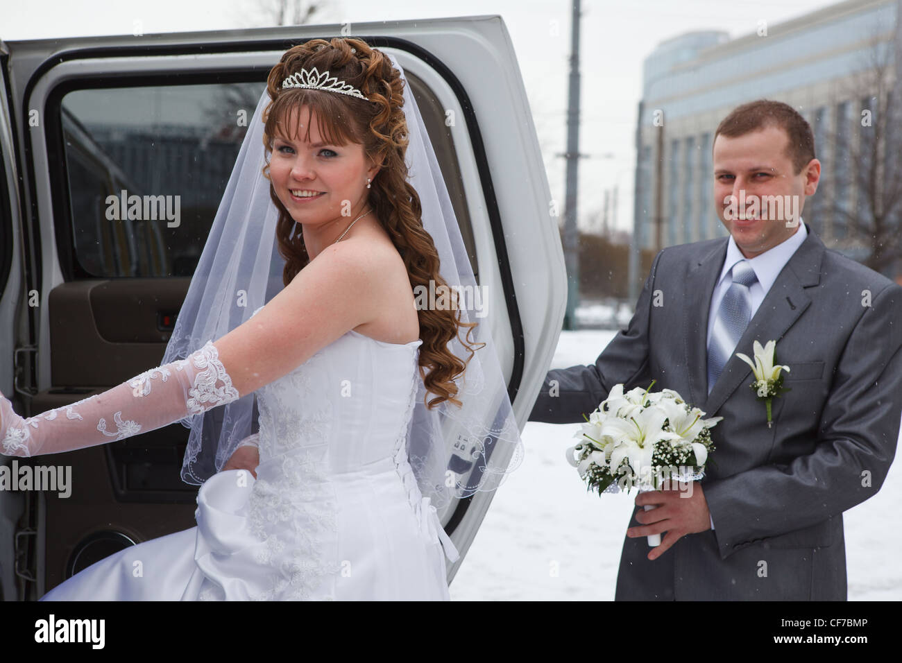 Bride and groom standing near car limousine in winter season Stock ...