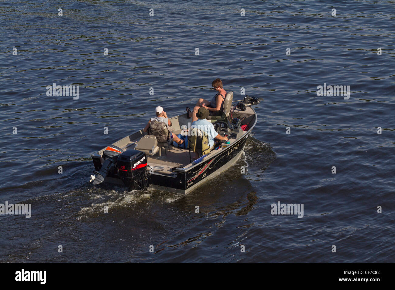 A float on tin boat with tourists sails down the River Wisconsin La Crosse Mississippi River in