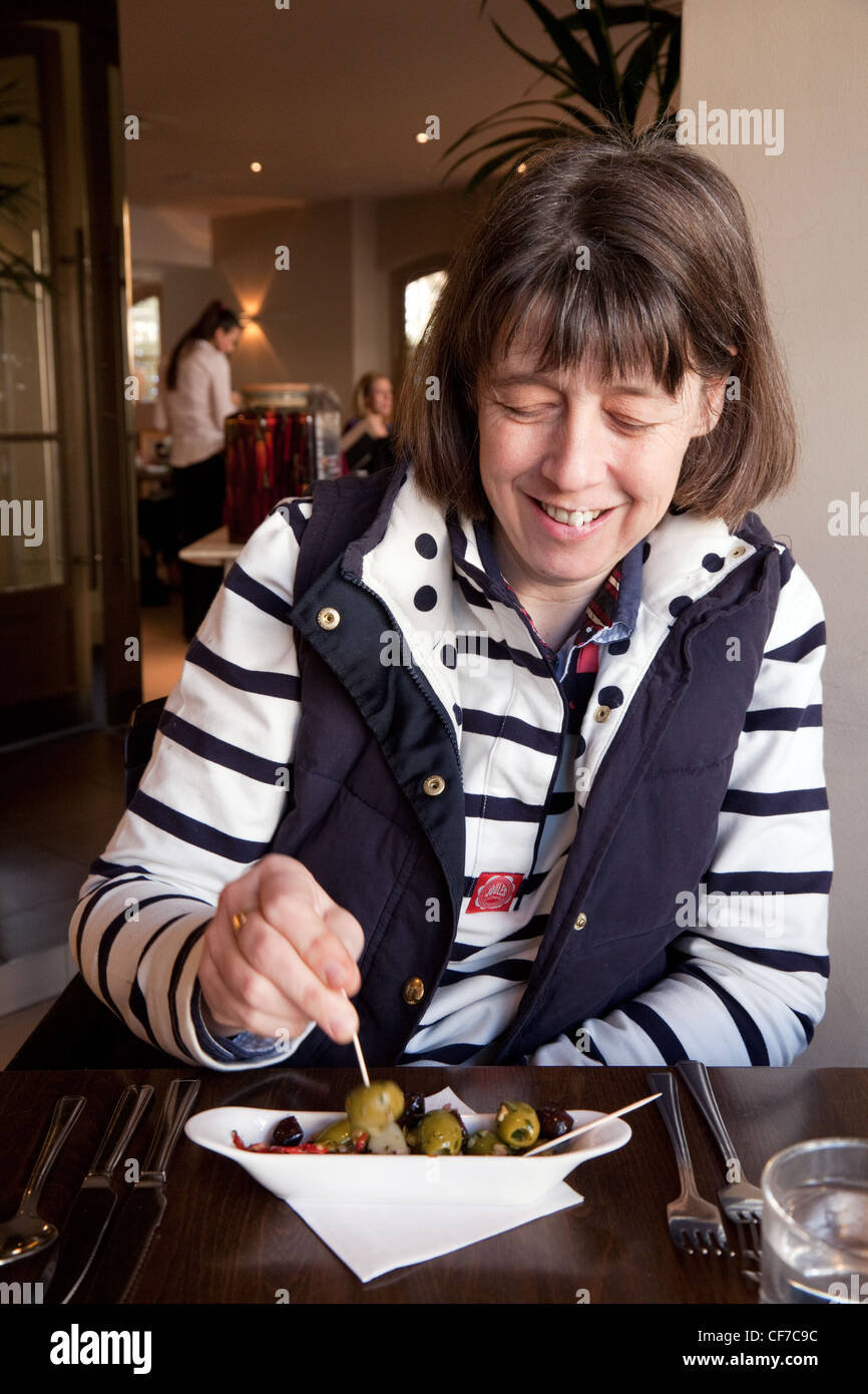 Woman eating olives in a Prezzo restaurant in the UK Stock Photo
