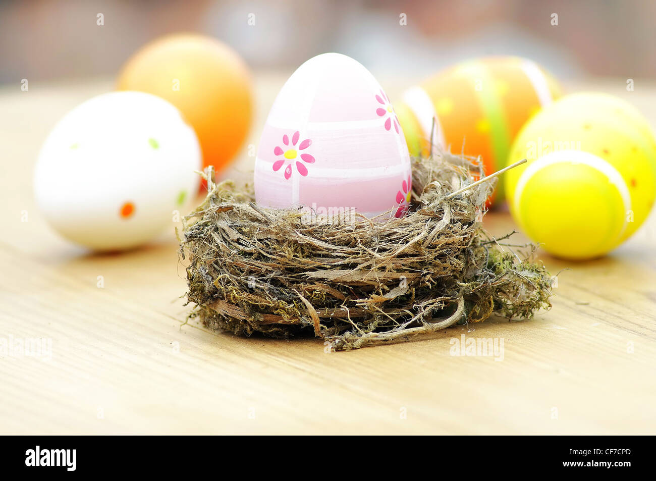 Beautiful eggs in the nest in wood background Stock Photo - Alamy