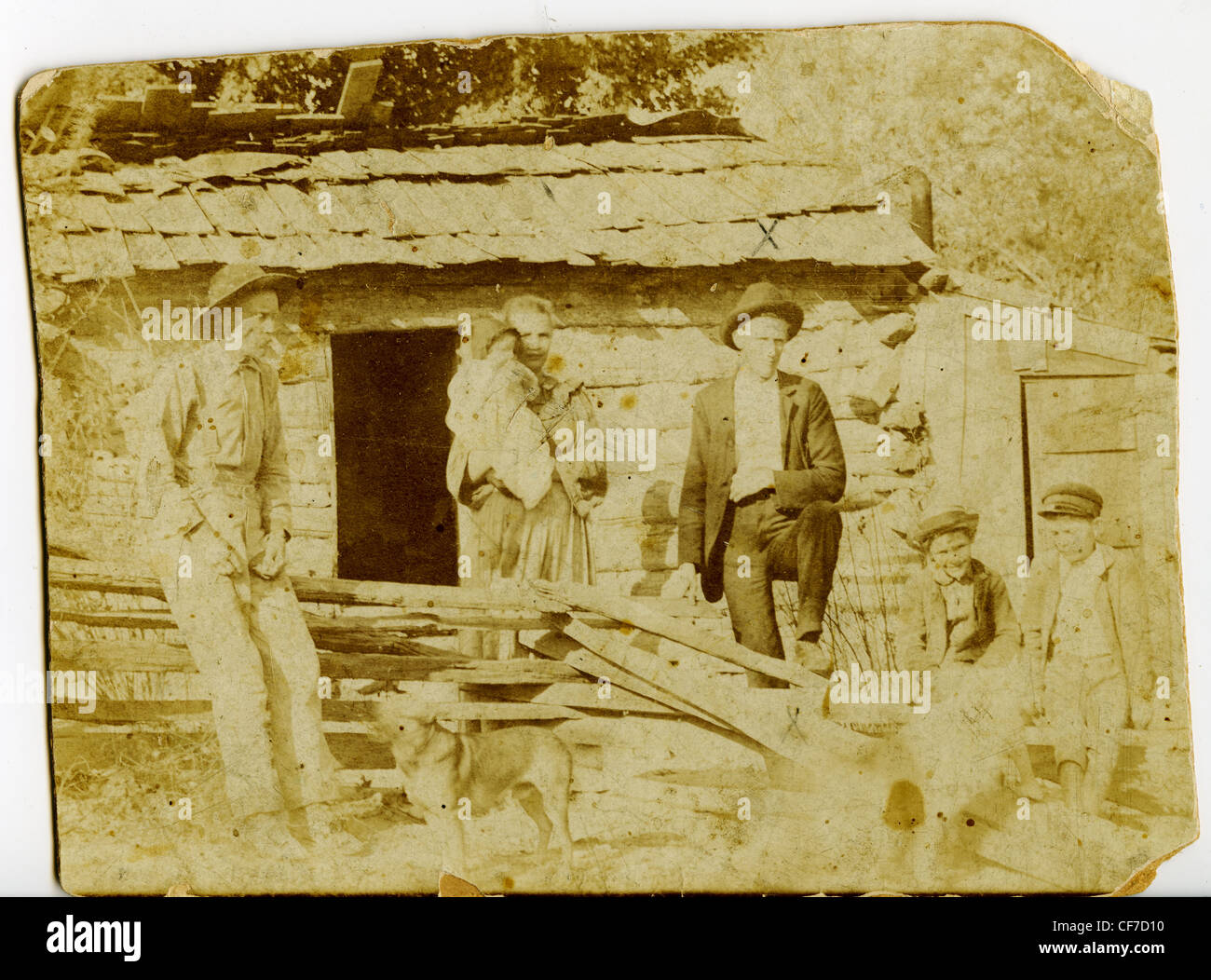 Pioneer family standing in front of their log cabin during the late 1800s homesteaders Indiana wood house family photo albumen p Stock Photo