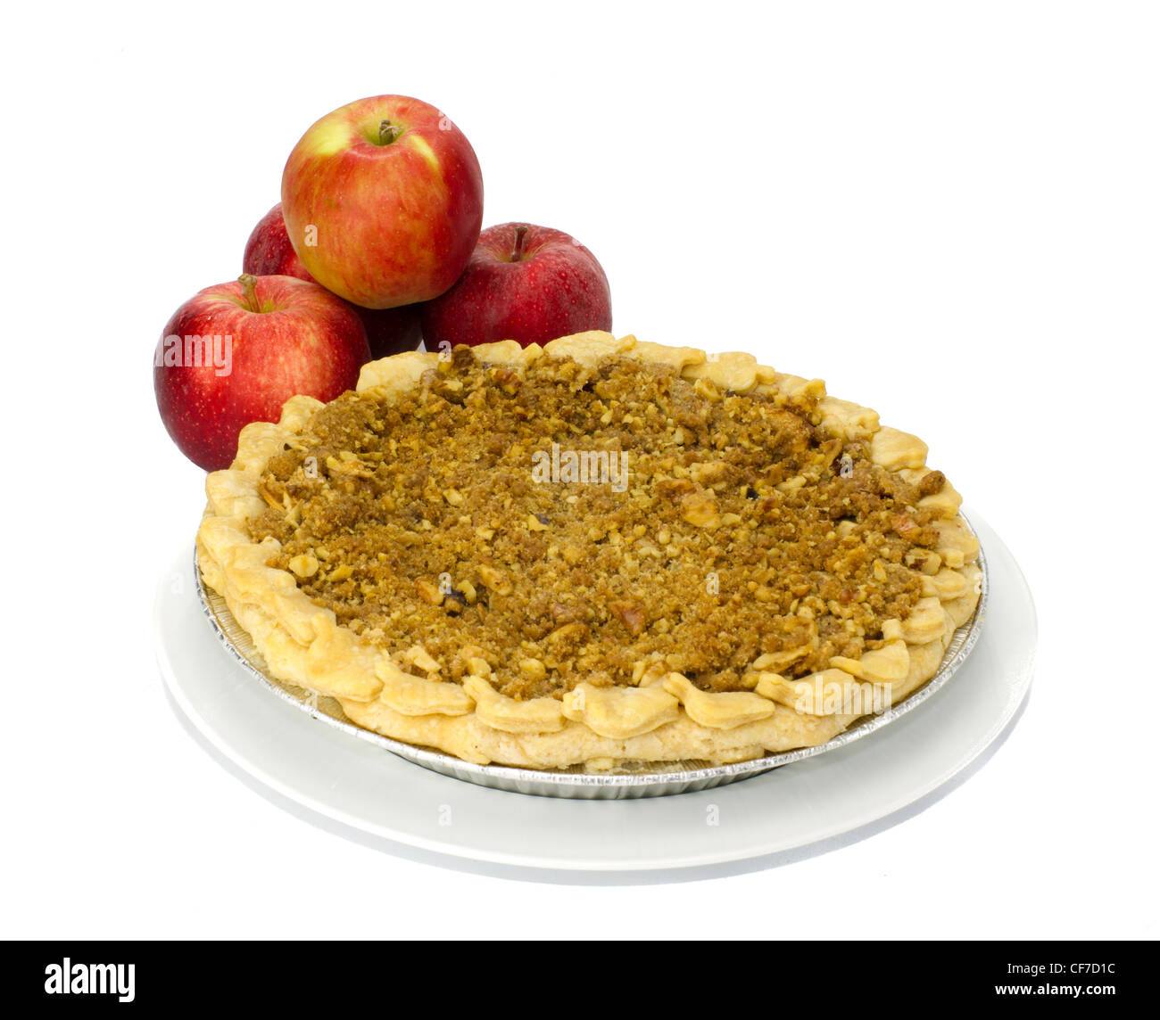 Freshly baked apple pie on white plate with red apples Stock Photo