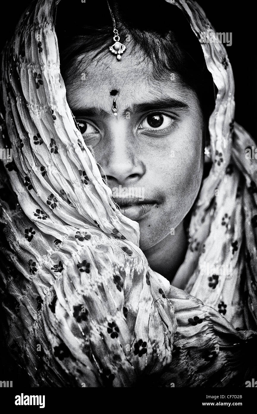 Happy Indian girl wearing a black shawl. Monochrome Stock Photo