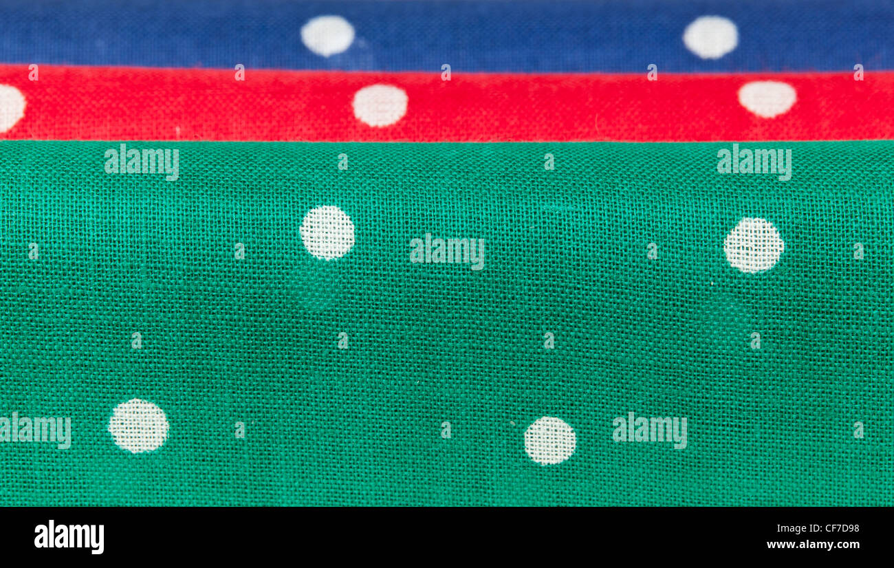 Folder linen handkerchiefs in red blue and green with white spots Stock Photo