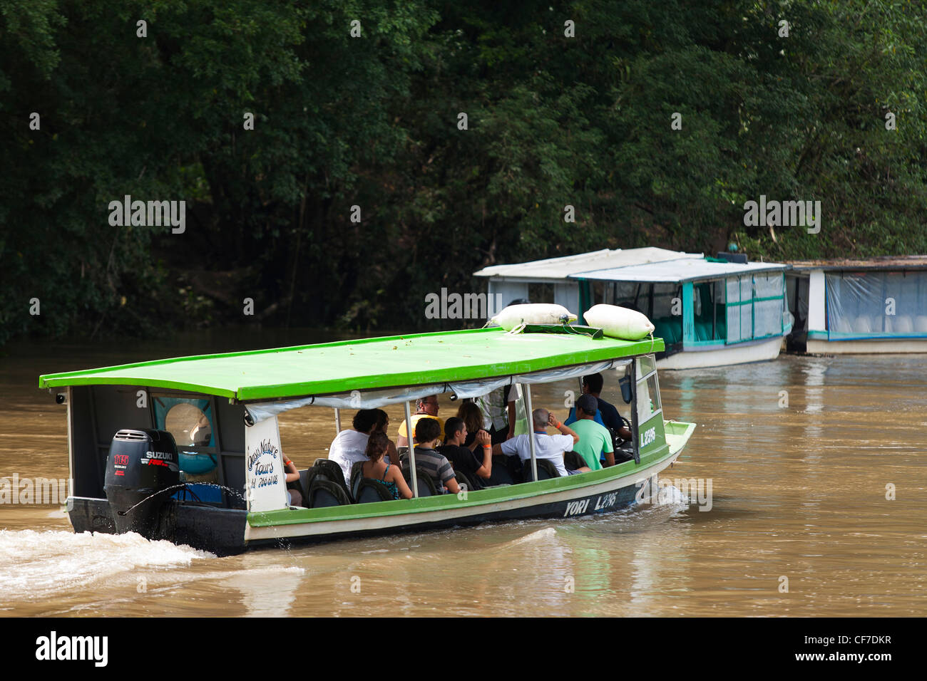 A tour boat taking tourists on a river tour on the Rio Sarapiqui in Puerto Viejo de Sarapiqui in Costa Rica Stock Photo