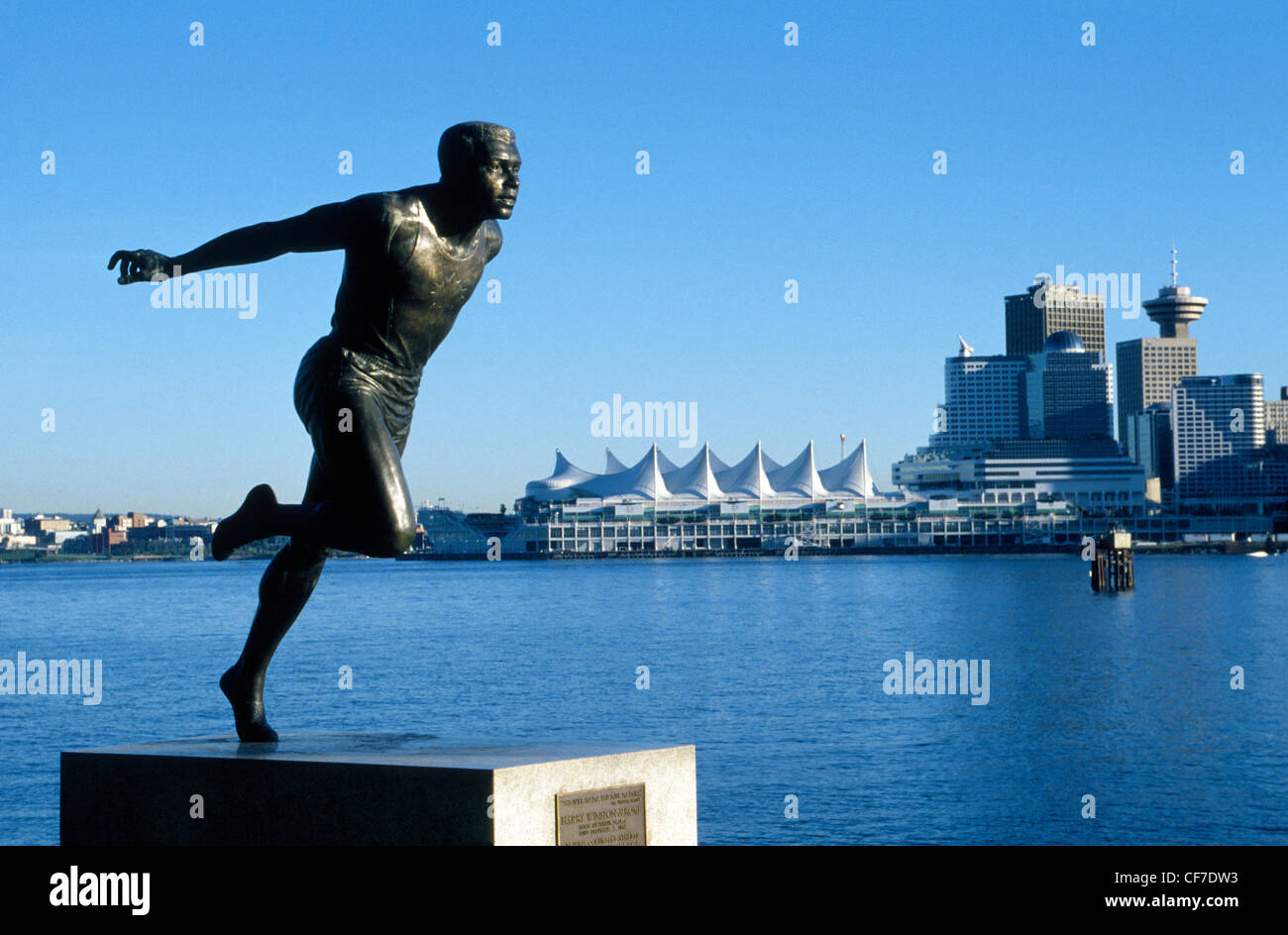 A statue in Stanley Park honoring Canada's famed black Olympic runner Harry Winston Jerome overlooks Vancouver and its harbor in British Columbia. Stock Photo