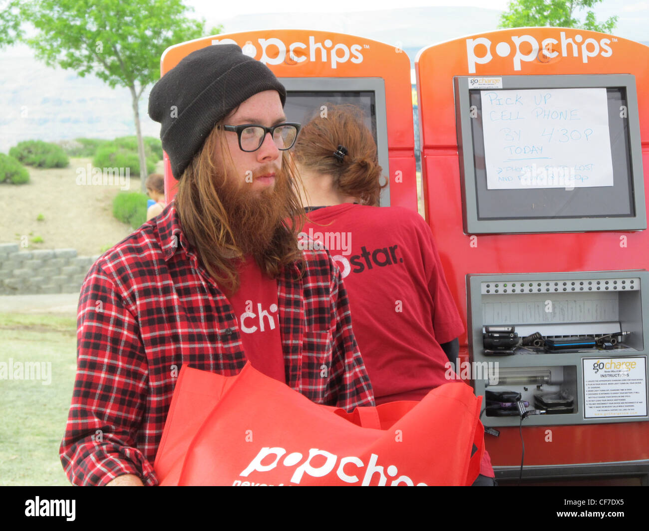 Hipster man from Portland promoting Pop chips at a rock concert. Stock Photo