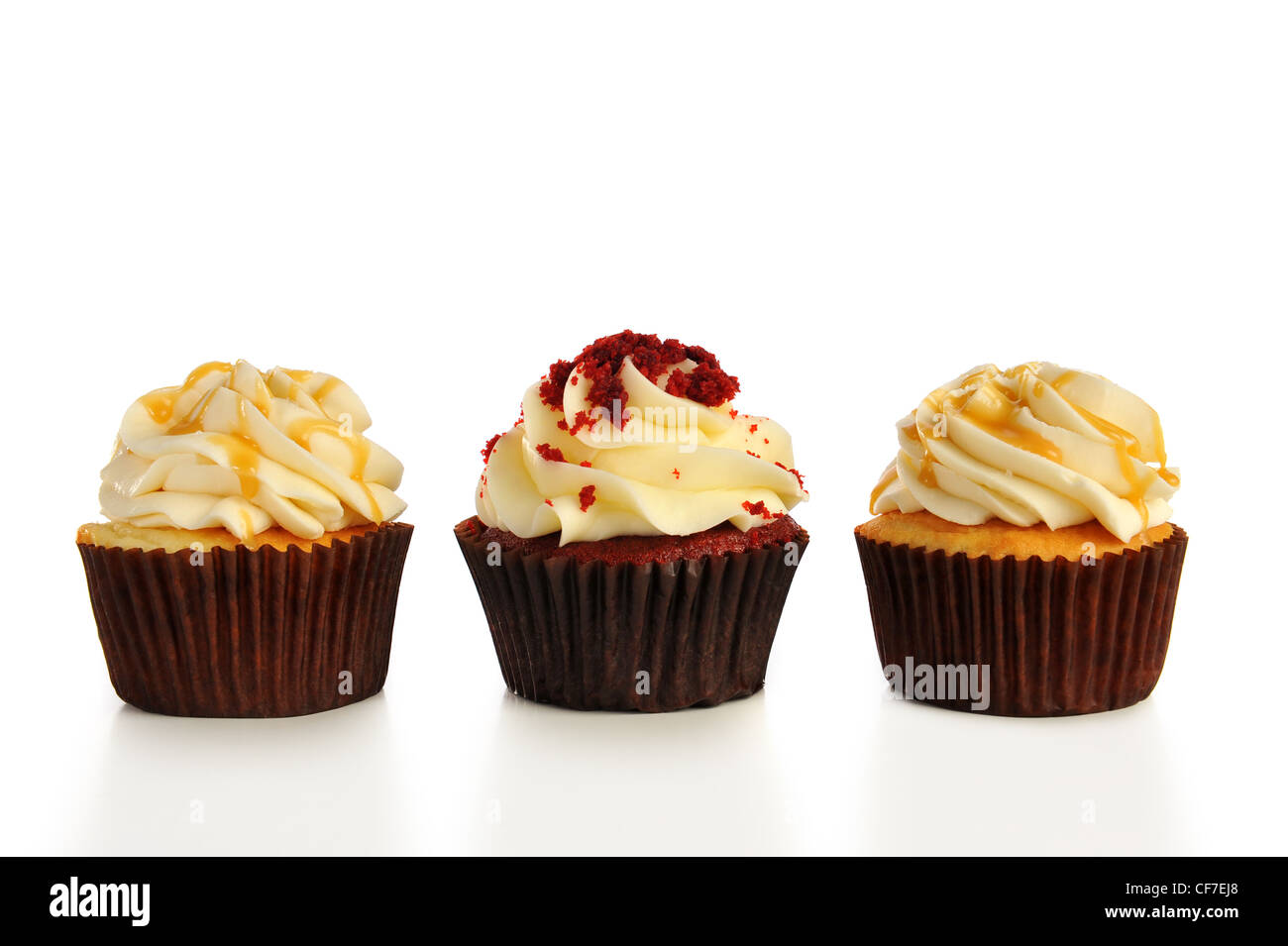 Three cupcakes in a row. Isolated on white Stock Photo - Alamy