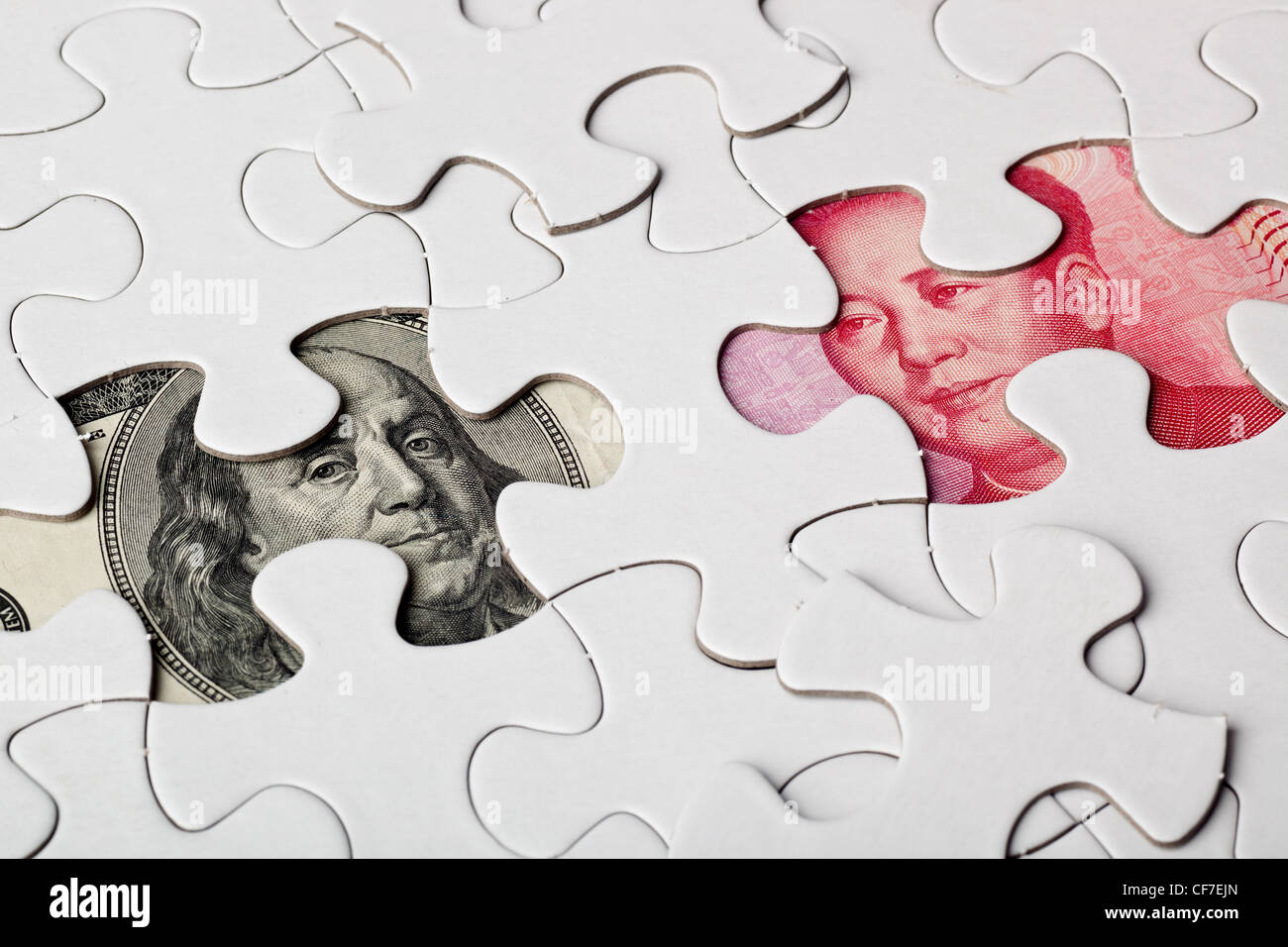 US and Chinese currencies as part of a jigsaw puzzle Stock Photo