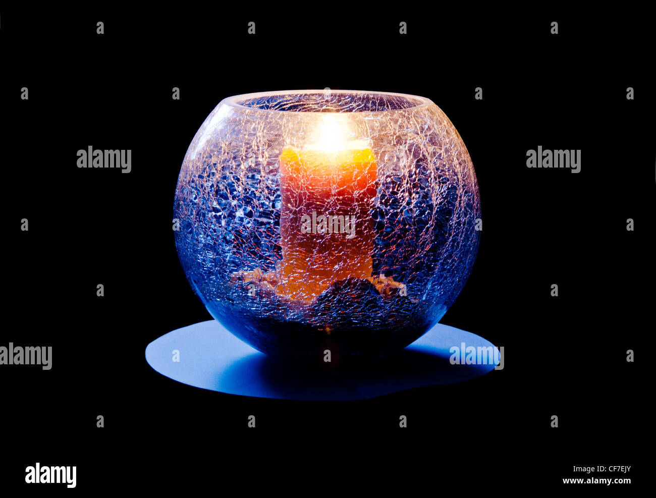 Lit candle in a cracked glass bowl Stock Photo Alamy