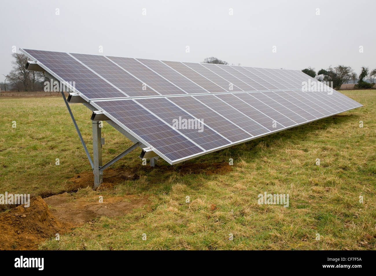 Array of photovoltaic panels stands in field Stock Photo