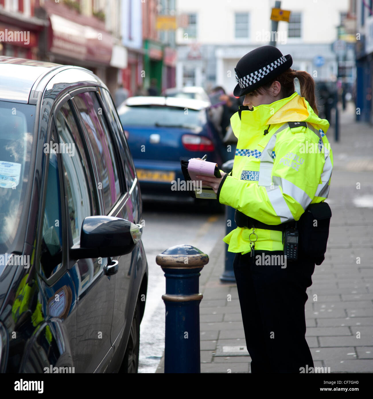 A Woman Dyfed Powys Police Officer Issuing Parking Ticket To A Car Parked On Double Yellow Lines