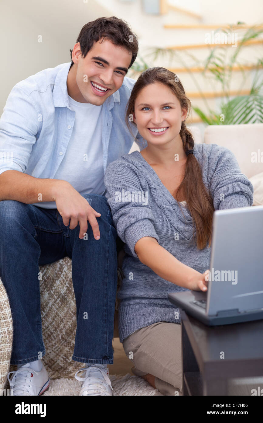 Portrait of a radiant couple using a notebook Stock Photo
