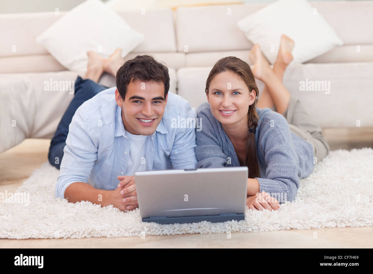 Cute couple posing with a laptop Stock Photo - Alamy