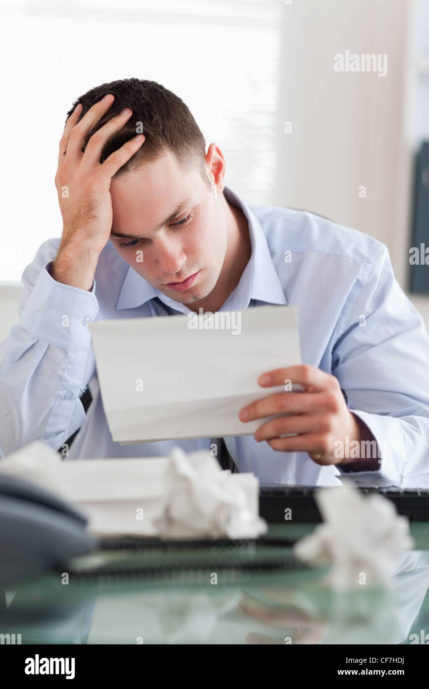 Businessman reading a bill Stock Photo