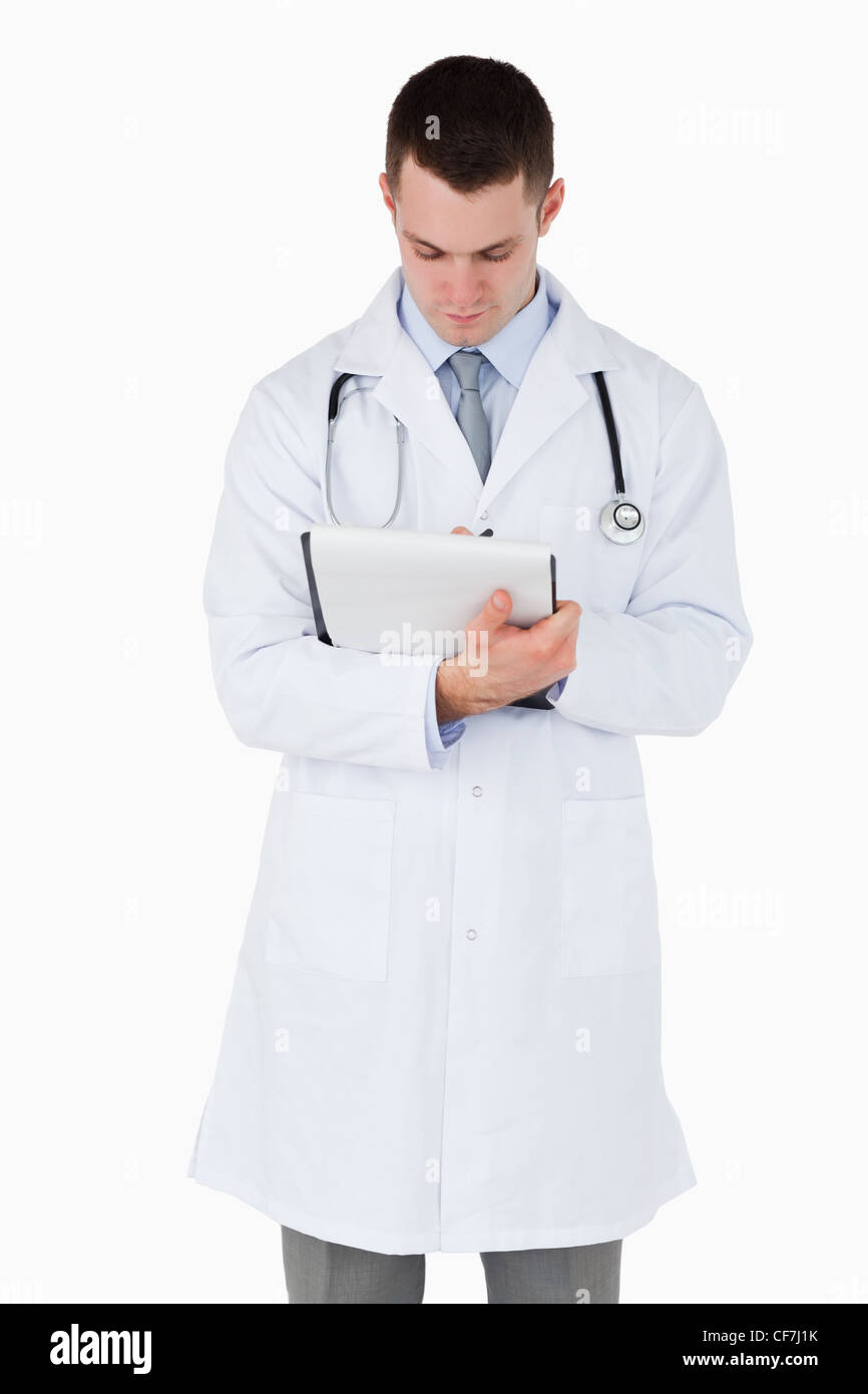Doctor taking a careful look at his notes Stock Photo