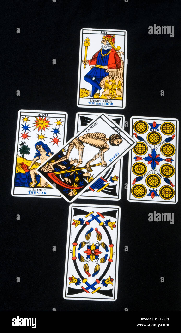 Tarot cards layed out in a cross with the Death card in the middle Stock Photo