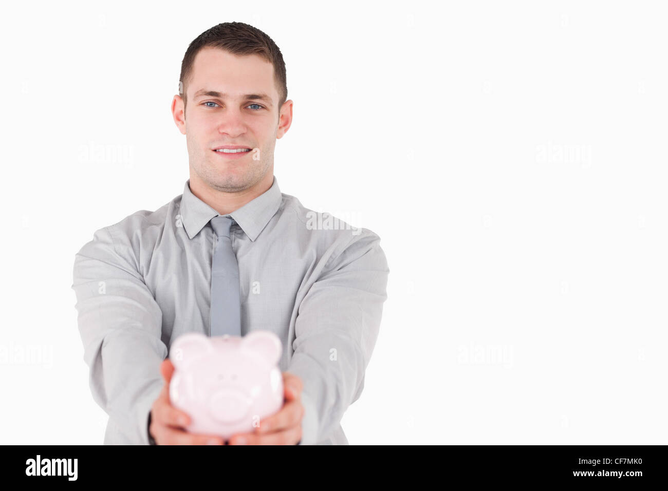 Businessman holding a piggy bank Stock Photo - Alamy