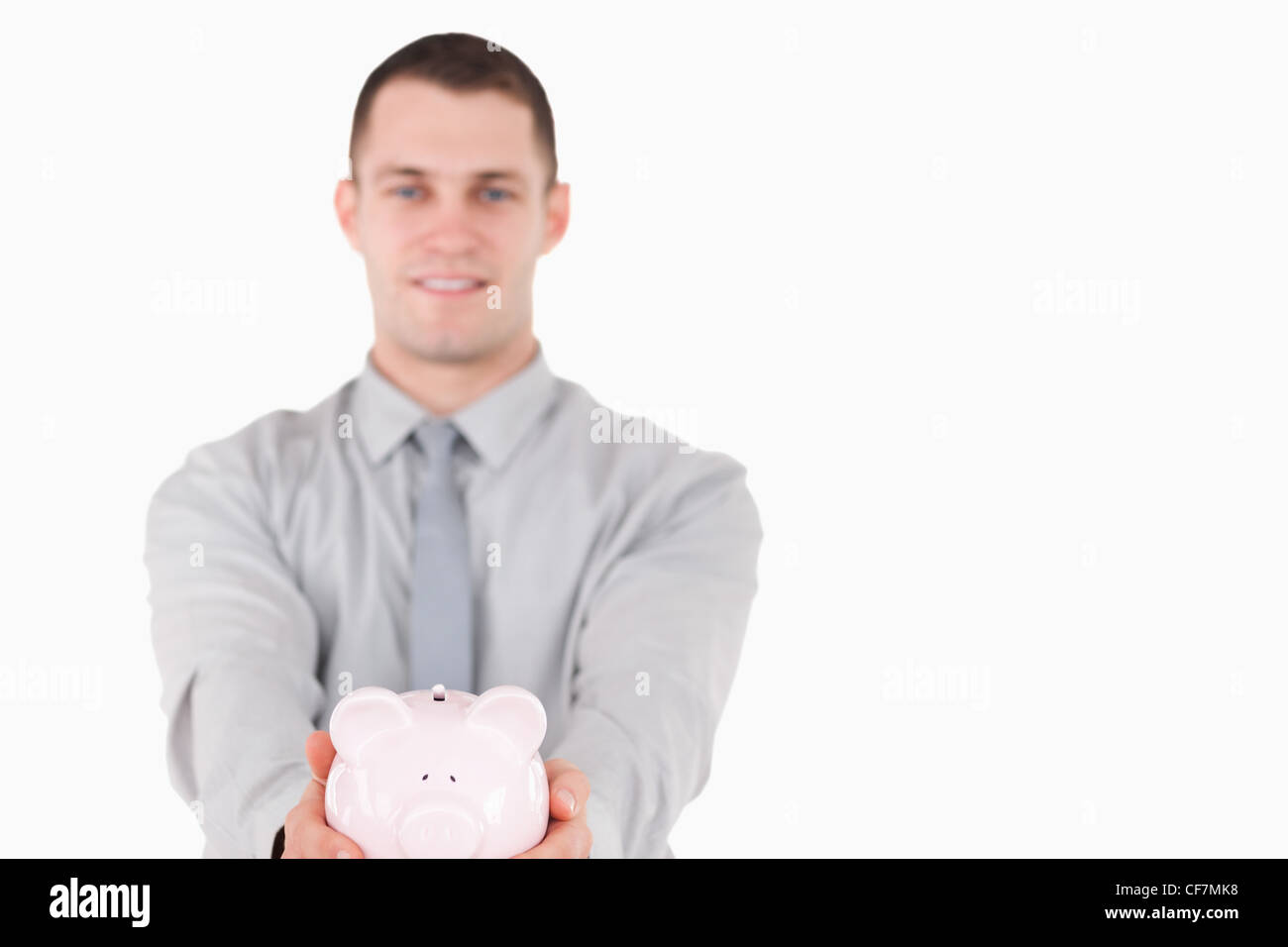 Young businessman holding a piggy bank Stock Photo - Alamy