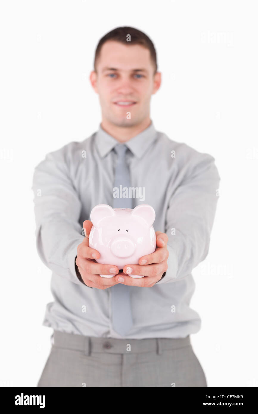 Portrait of a young businessman holding a piggy bank Stock Photo - Alamy