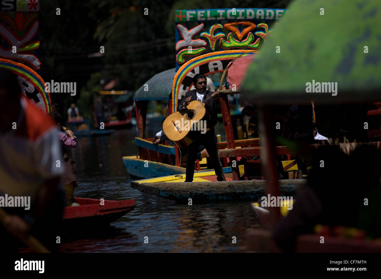 A mariachi musician play Mexican songs to tourists in a boat through ...