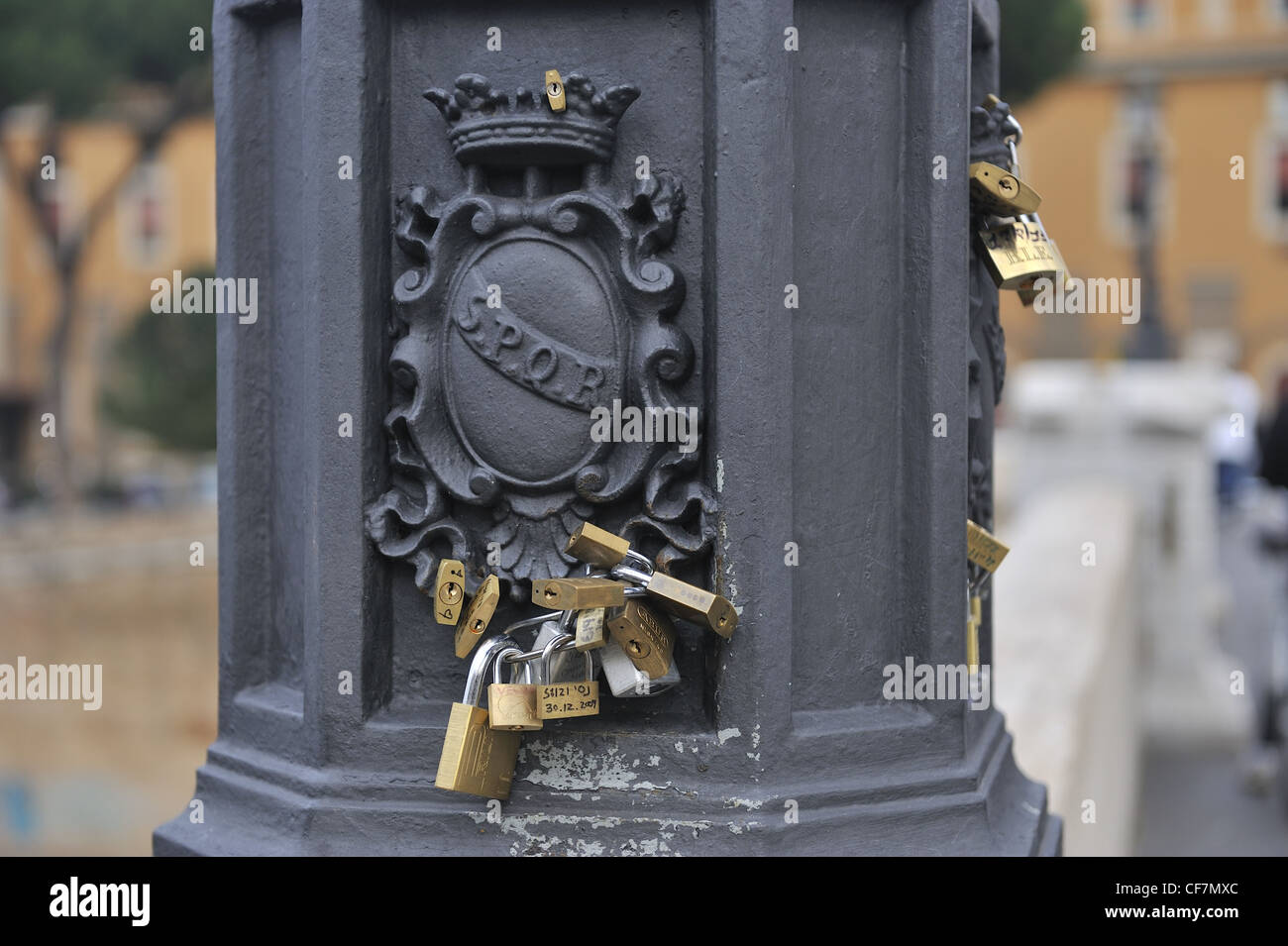 Love locks on lamp post on a bridge in Rome Stock Photo