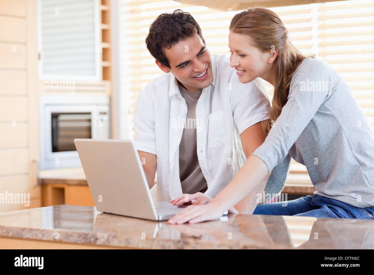 Couple laptop in kitchen hi-res stock photography and images - Alamy