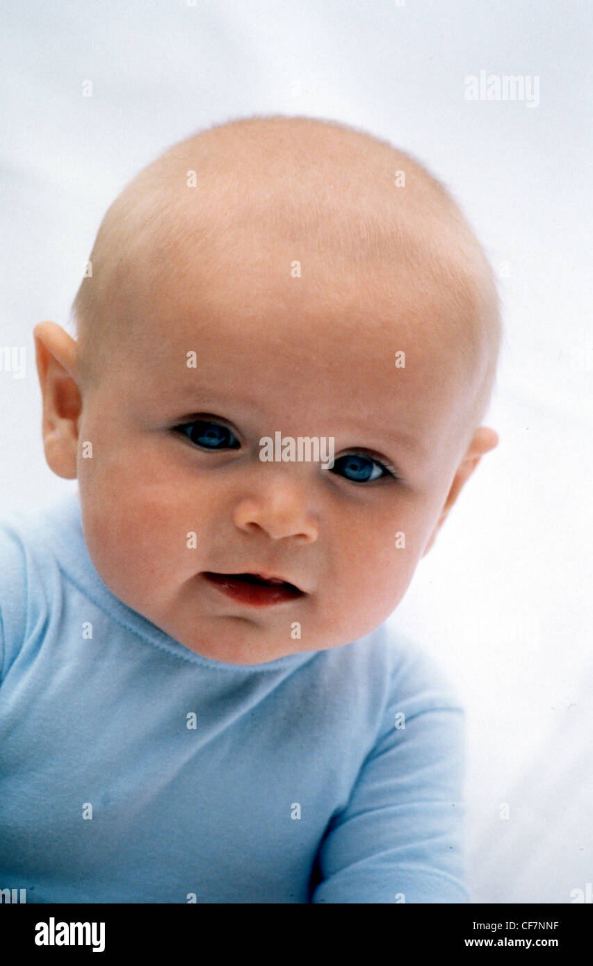 MMale baby, wearing a blue top, unsmiling, looking at camera Stock Photo