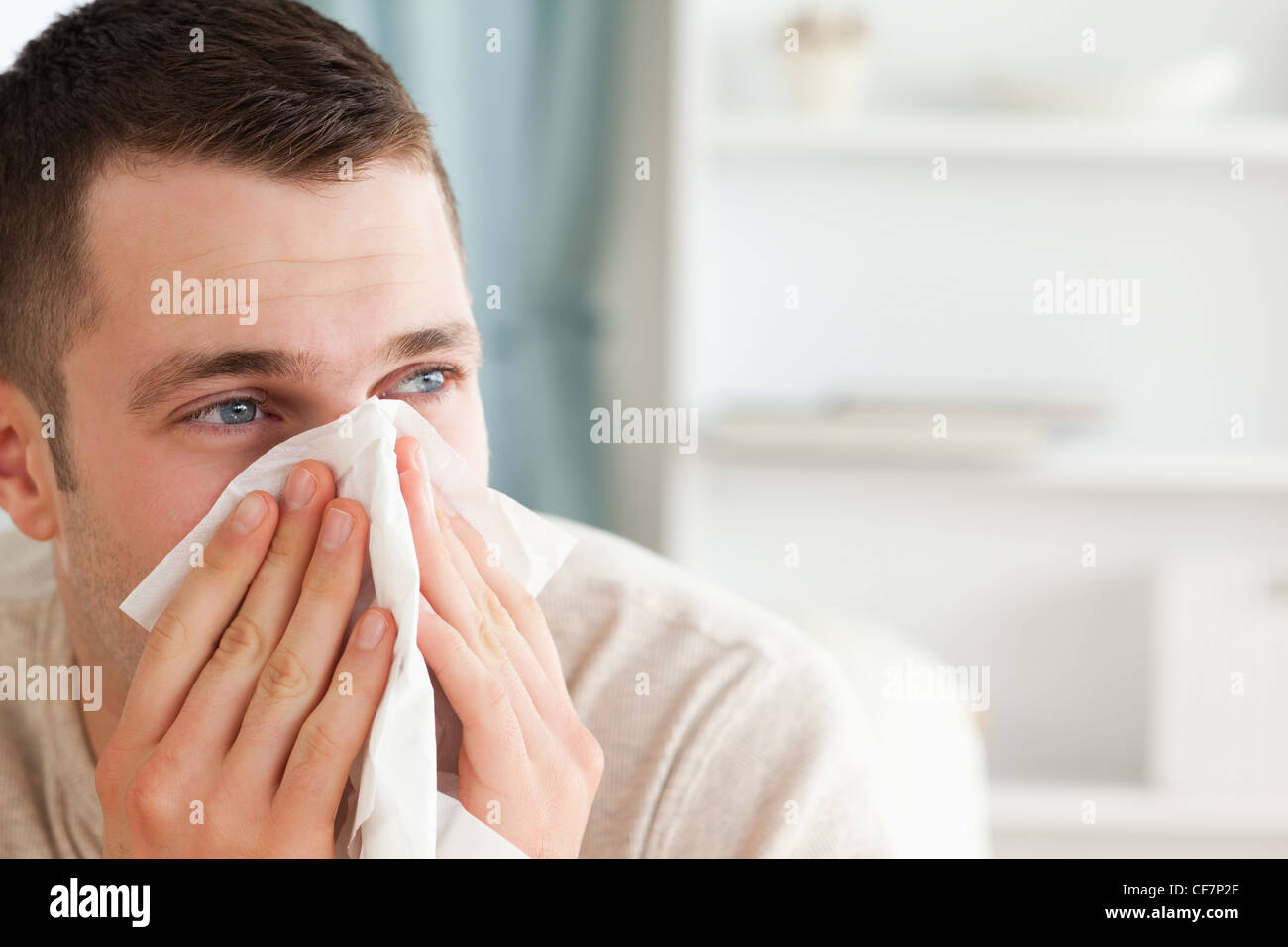 Sick man blowing his nose Stock Photo Alamy