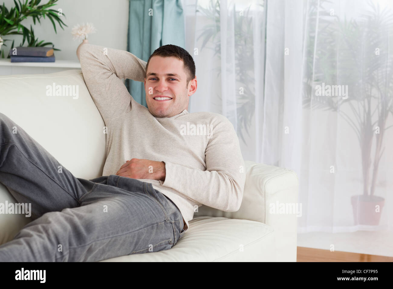 Man Lying On A Sofa Stock Photo Alamy