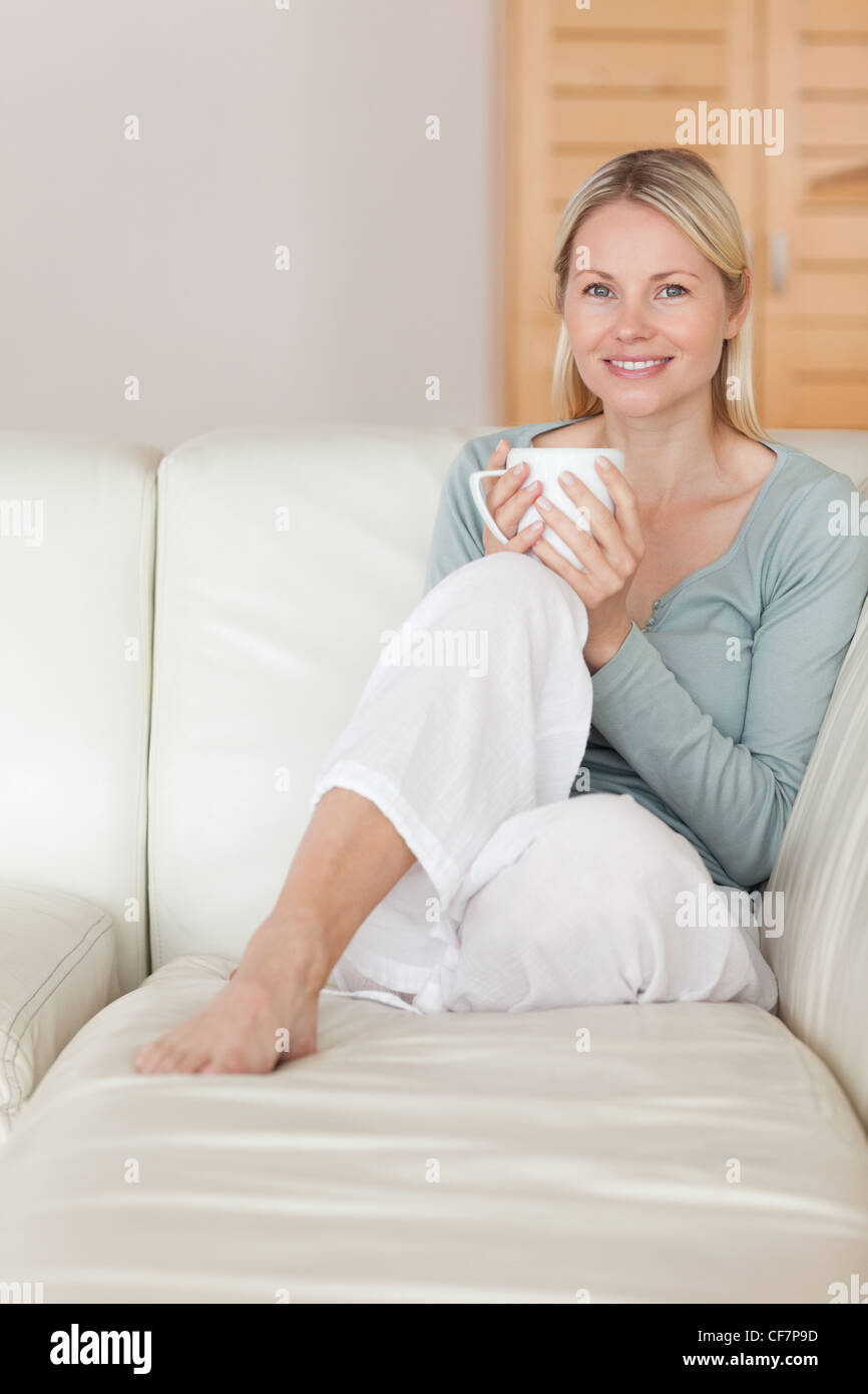 Woman relaxing on the couch with a cup of coffee Stock Photo - Alamy