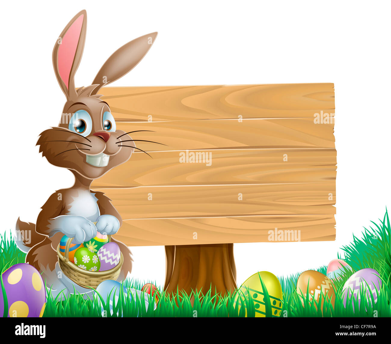 The Easter bunny holding a basket of Easter eggs with more Easter eggs around him by a wood sign board Stock Photo