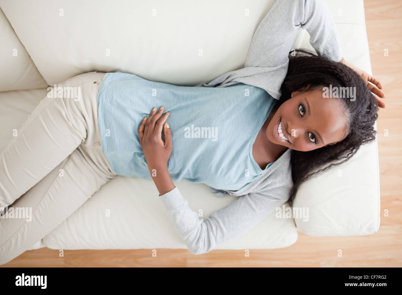 Woman taking a break on the sofa Stock Photo Alamy