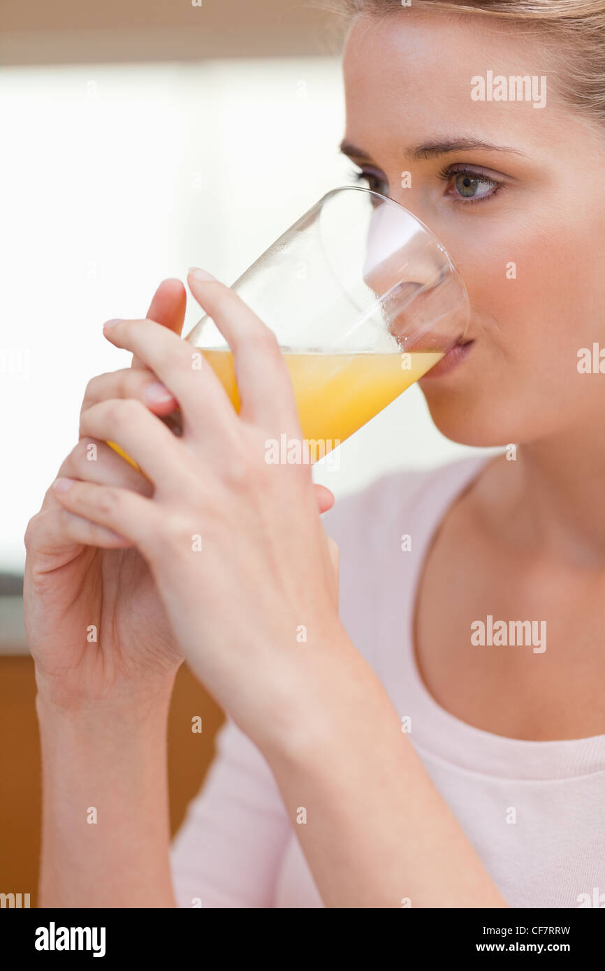 Portrait of a quiet woman drinking juice Stock Photo Alamy