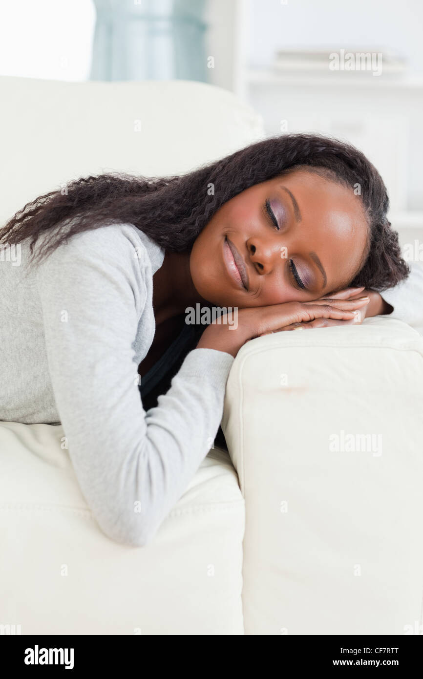 Woman lying on the sofa with eyes closed Stock Photo - Alamy