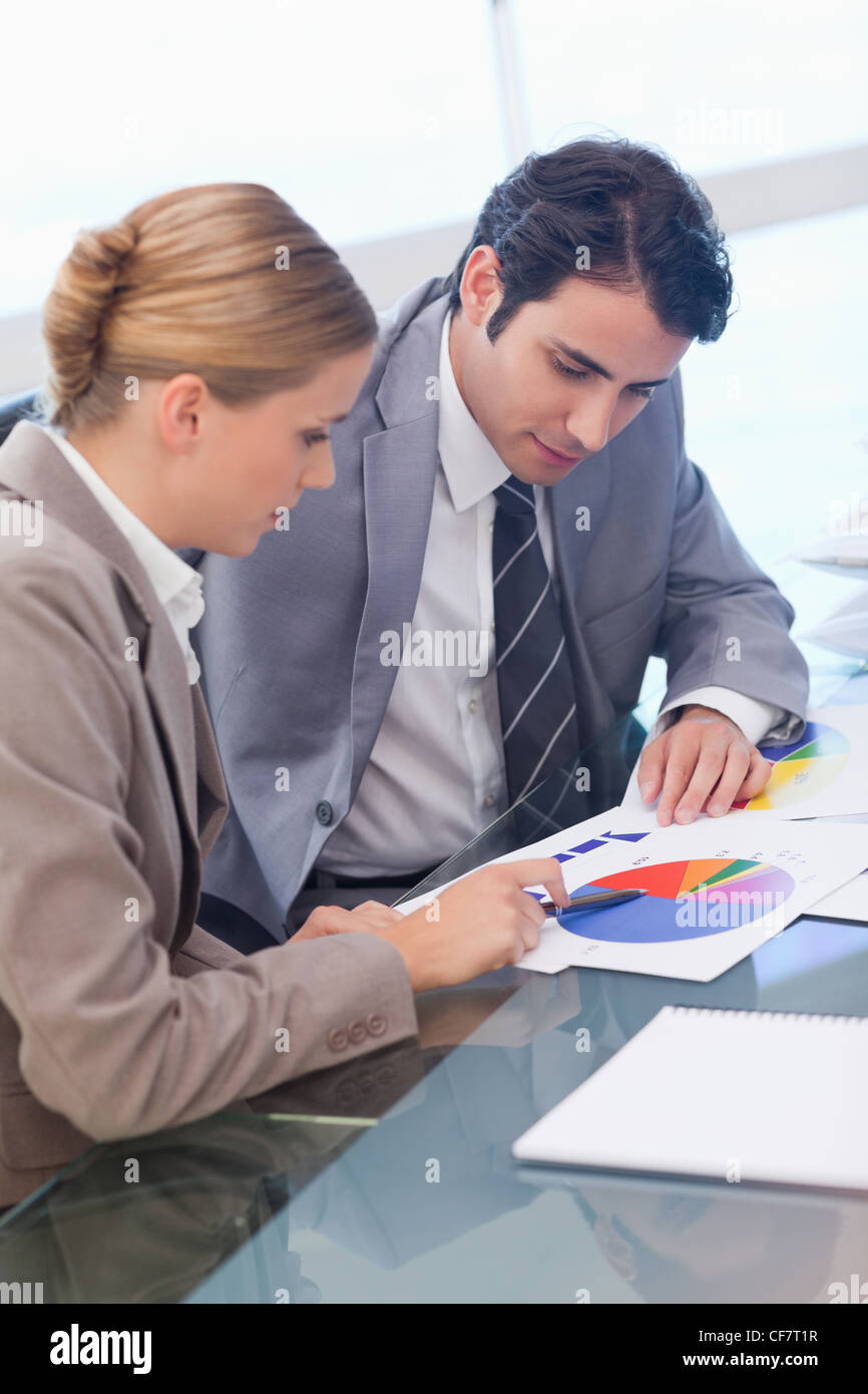 Portrait of business people studying statistics Stock Photo