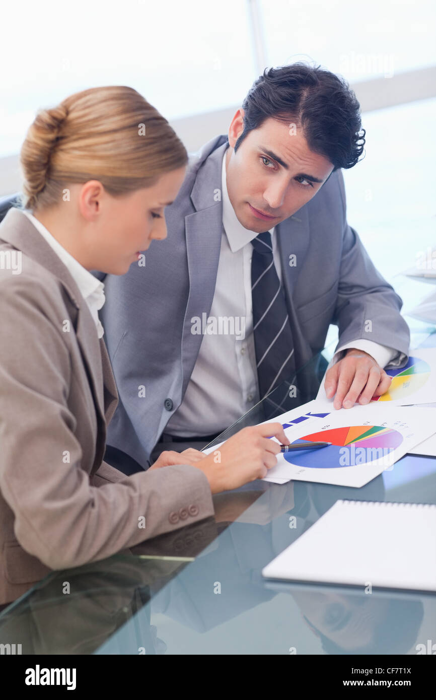 Portrait of young business people studying statistics Stock Photo