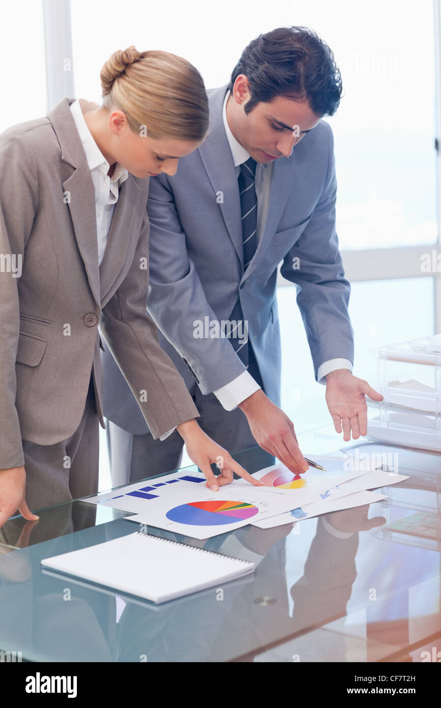 Portrait of serious business people looking at statistics Stock Photo