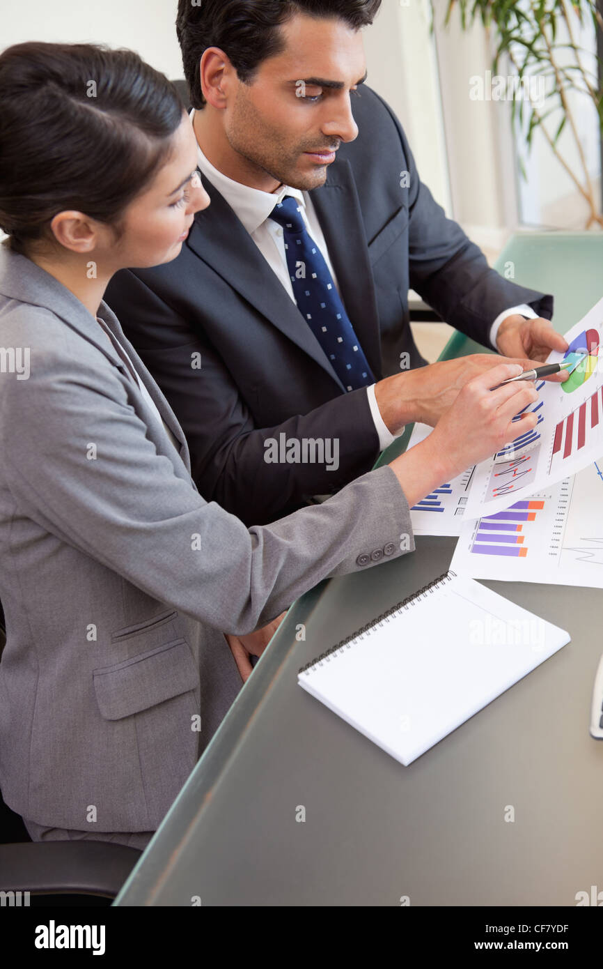 Portrait of young sales persons studying statistics Stock Photo
