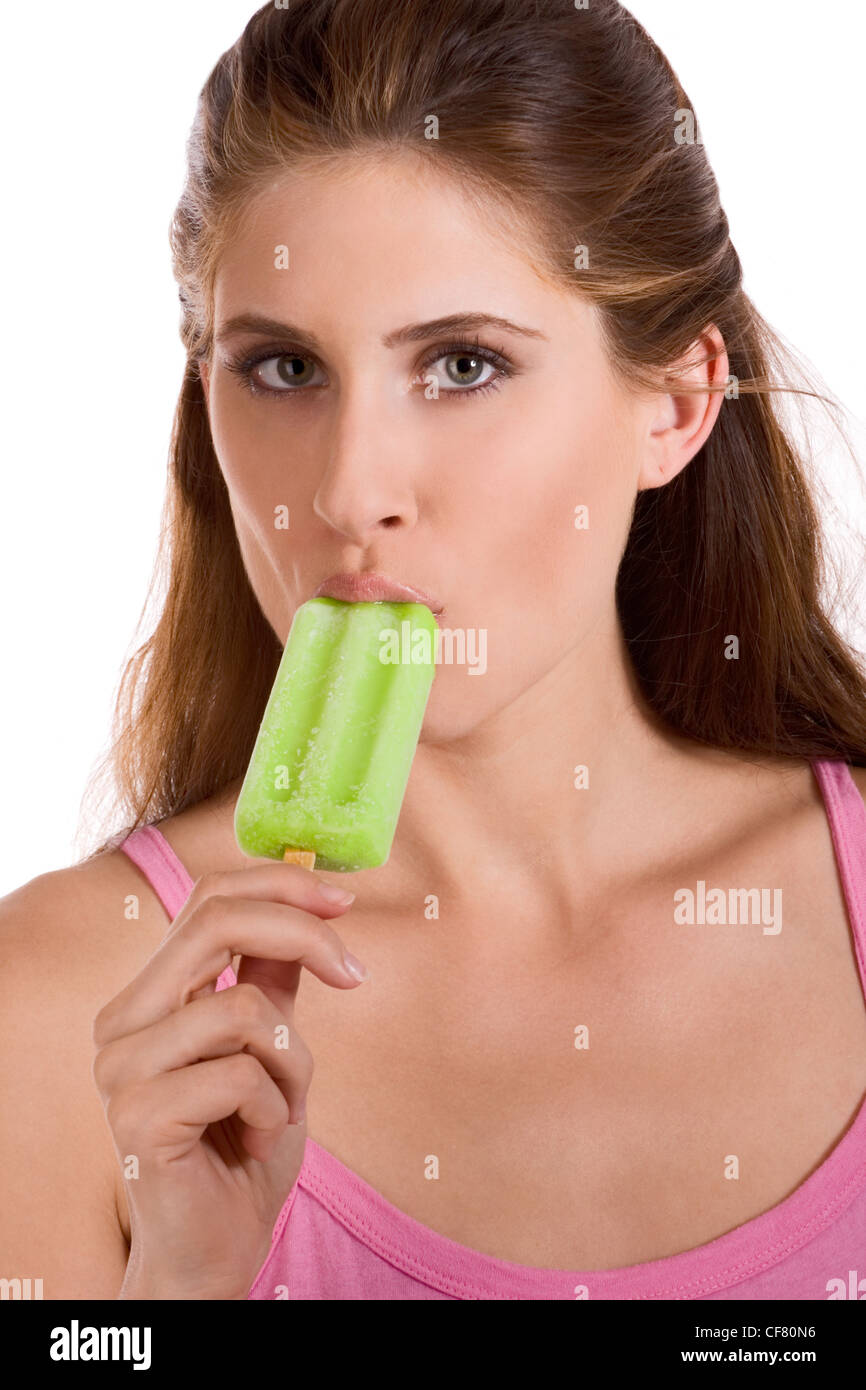 young female tasting sucking green Italian ice frozen dessert Stock Photo