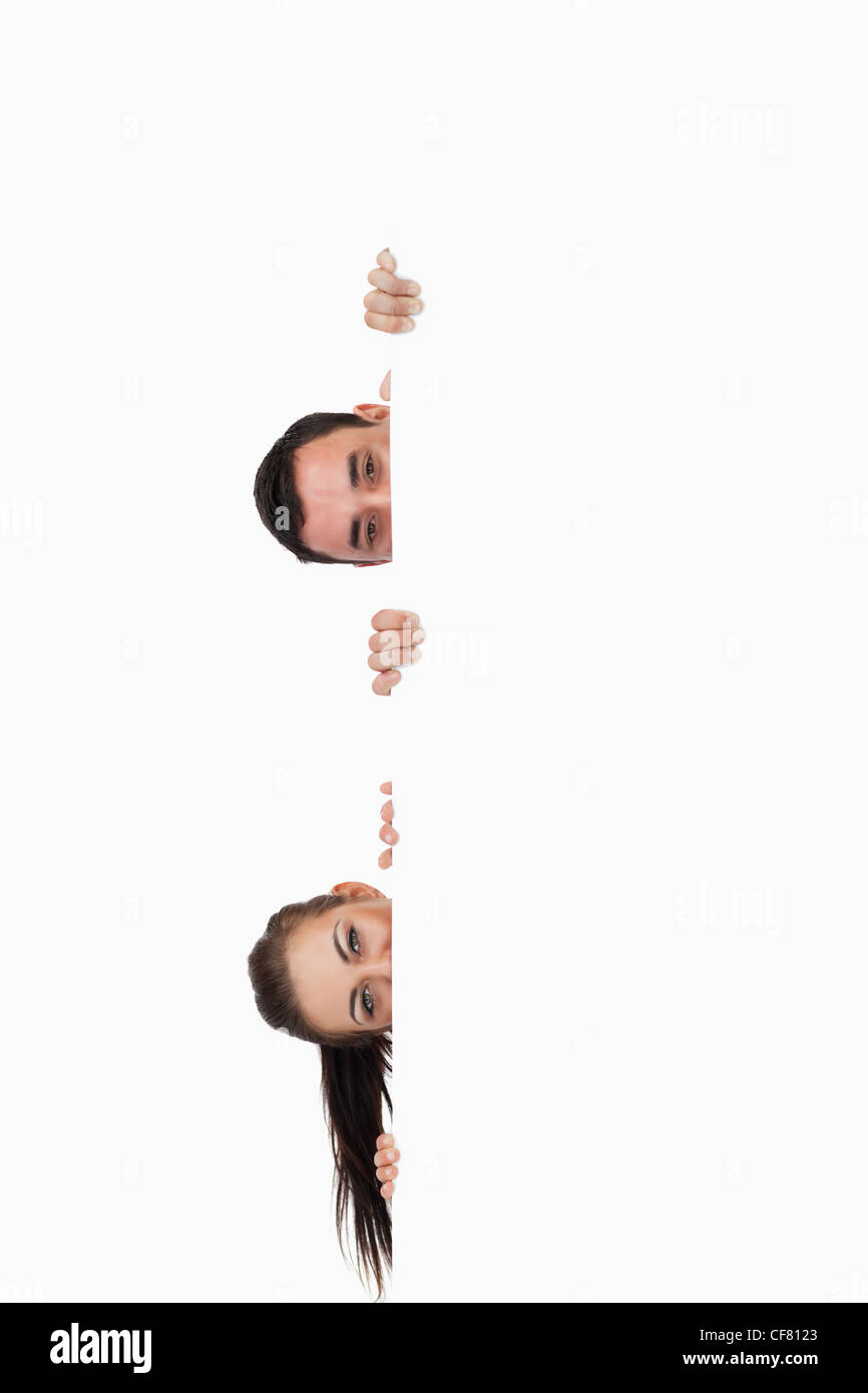 Young business partners looking around the corner Stock Photo Alamy