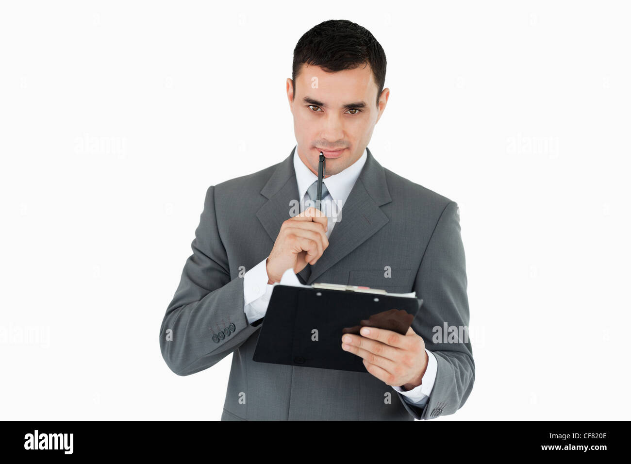 Businessman with pen and clipboard Stock Photo - Alamy