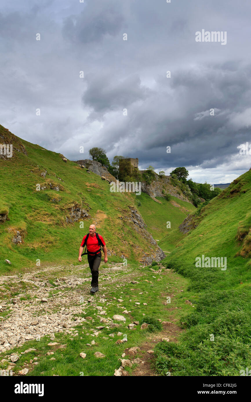 adult male walker, Cave Dale, Peveril Castle, Castleton village, Hope Valley, Peak District National Park, Derbyshire Dales Stock Photo
