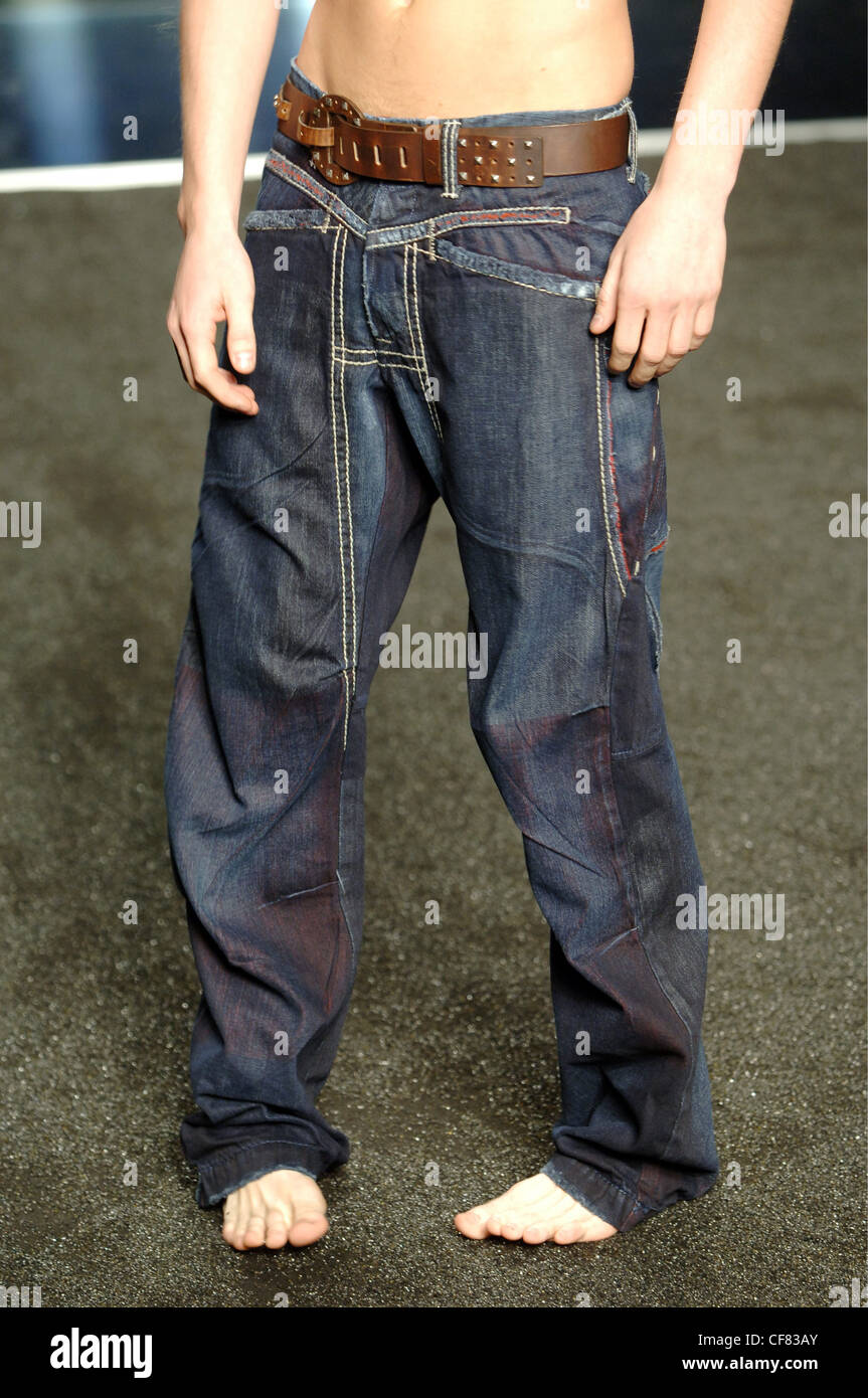 Girbaud Menswear Milan A W Cropped shot of a shirtless and barefoot male  wearing dark was baggy jeans with brown leather belt Stock Photo - Alamy