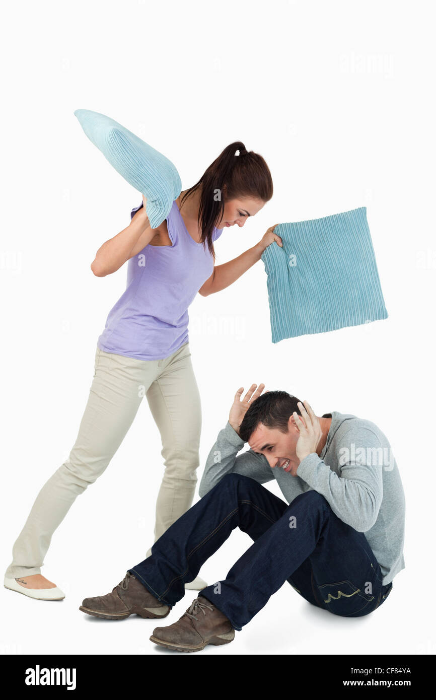 Young female hitting her boyfriend with pillows Stock Photo Alamy