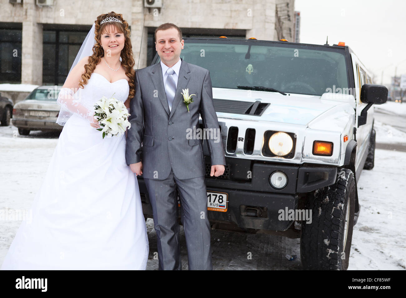 Bride and groom standing near car limousine in winter season Stock ...