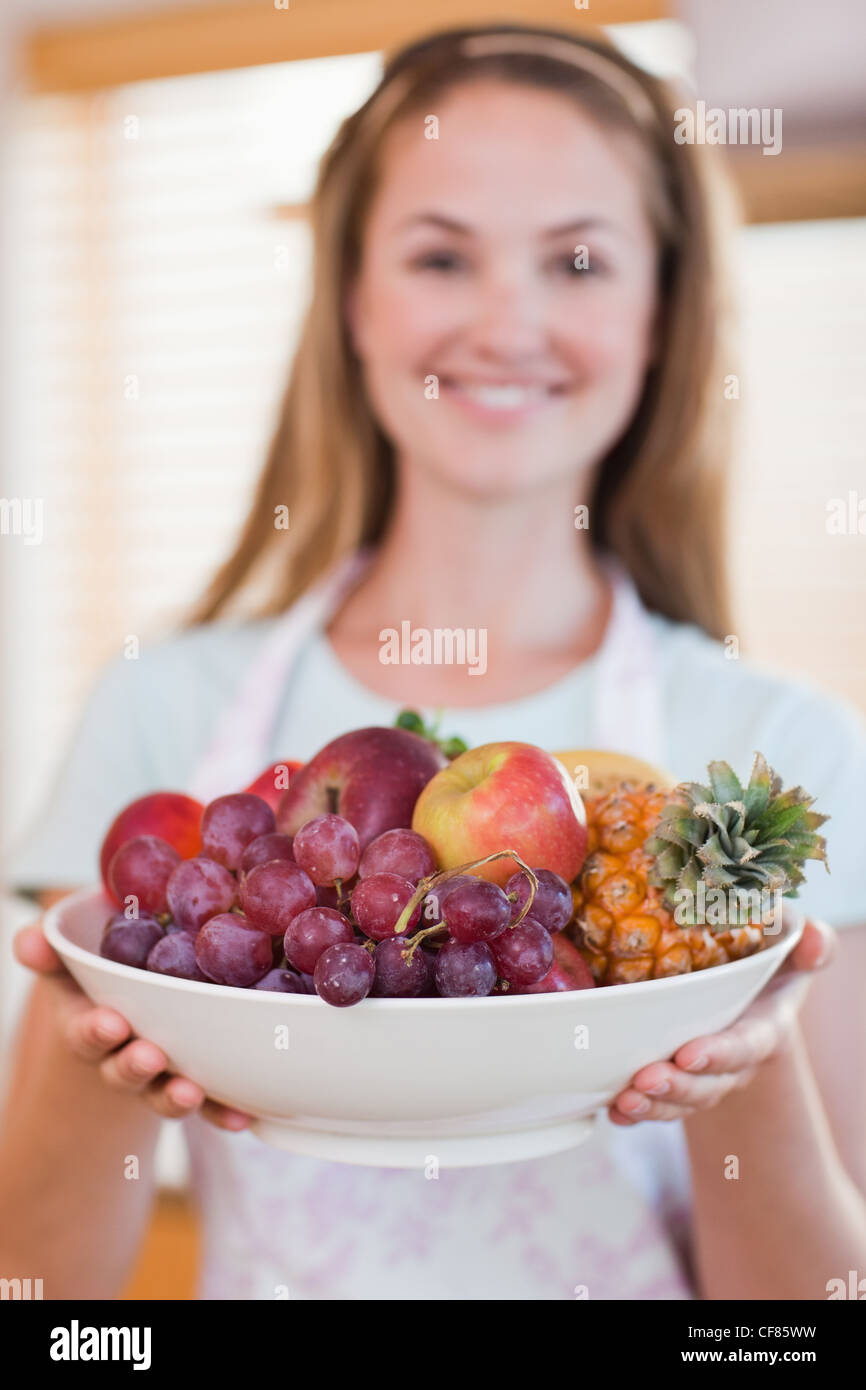 Portrait of a woman presenting a fruit basket Stock Photo - Alamy