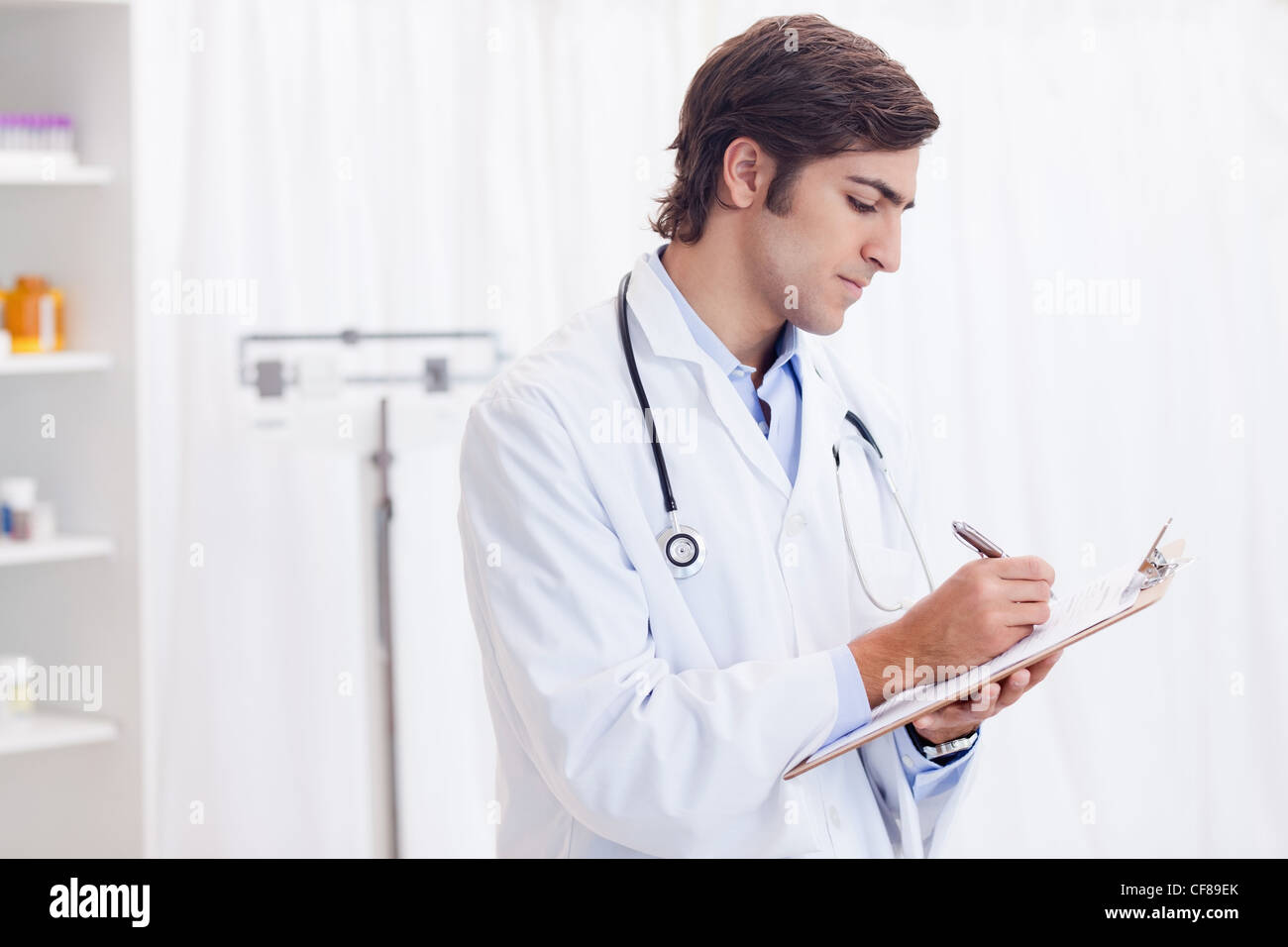 Side view of doctor taking notes Stock Photo - Alamy